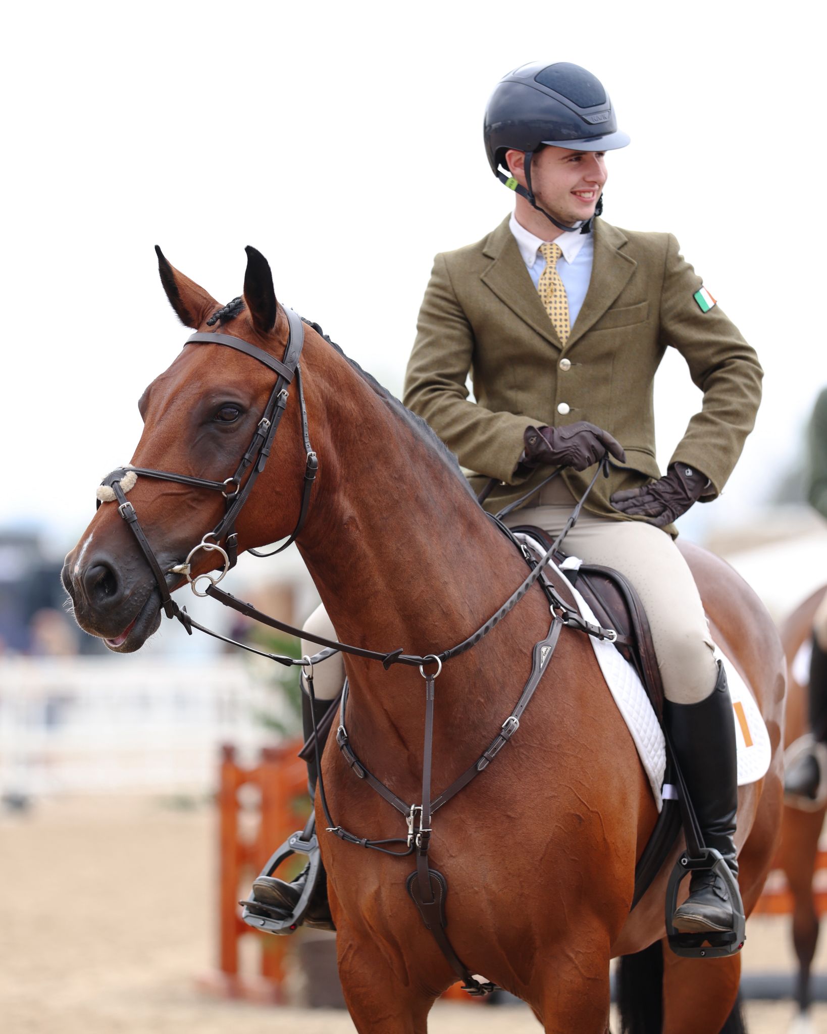 Max McDonnell sits with his hand on his hip and smiling aboard WKD Little Gift