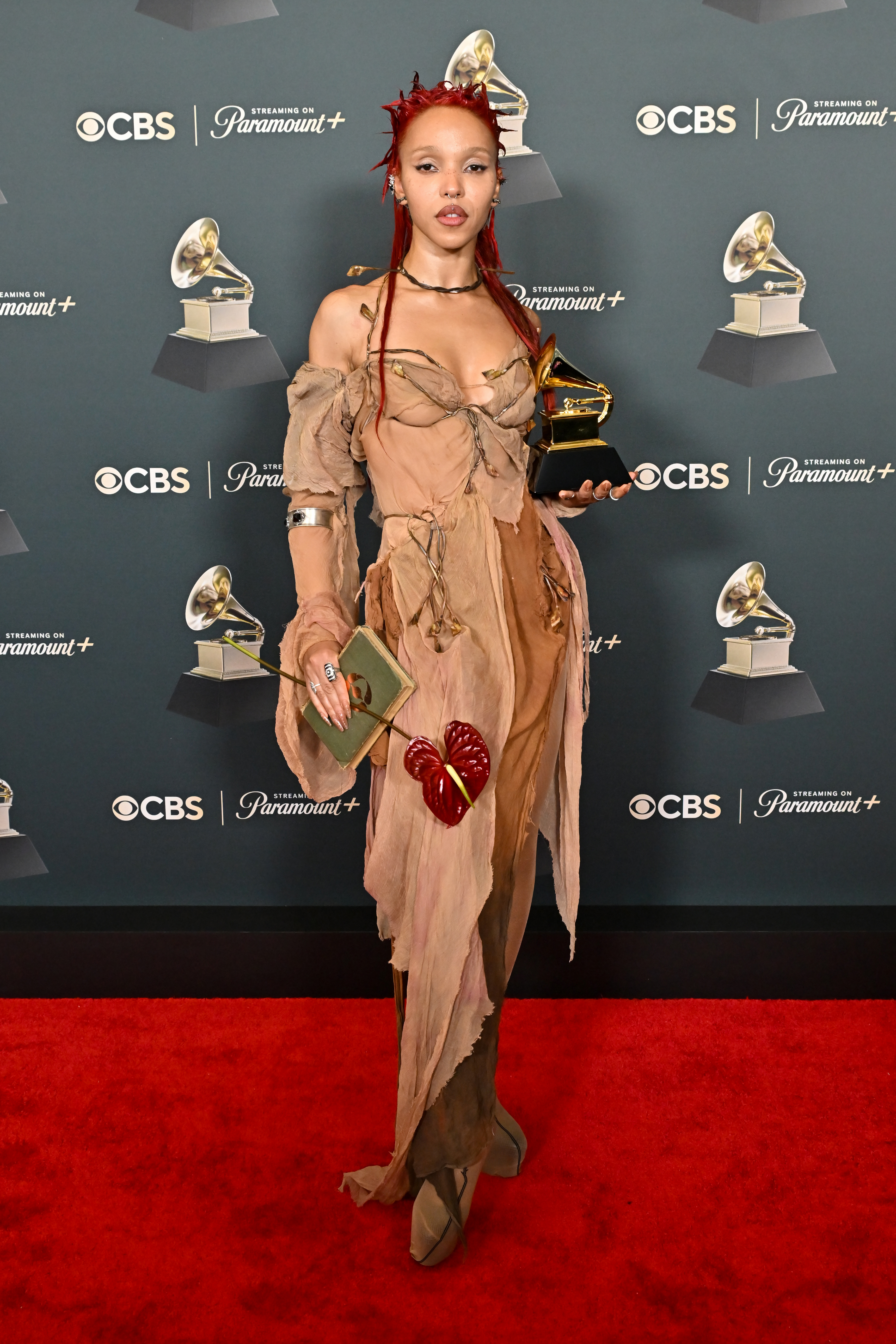 FKA Twigs carrying a book at the 2026 Grammys