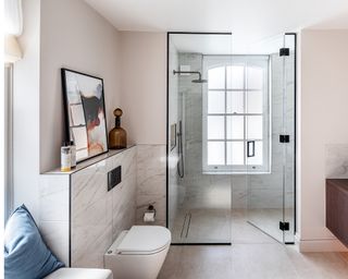 A master en-suite bathroom with walk-in shower and window seat