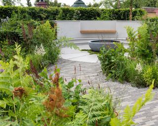 small water bowl on patio at The South West Water Green Garden. Designed by: Tom Simpson at RHS Hampton Court Palace Flower Show 2018