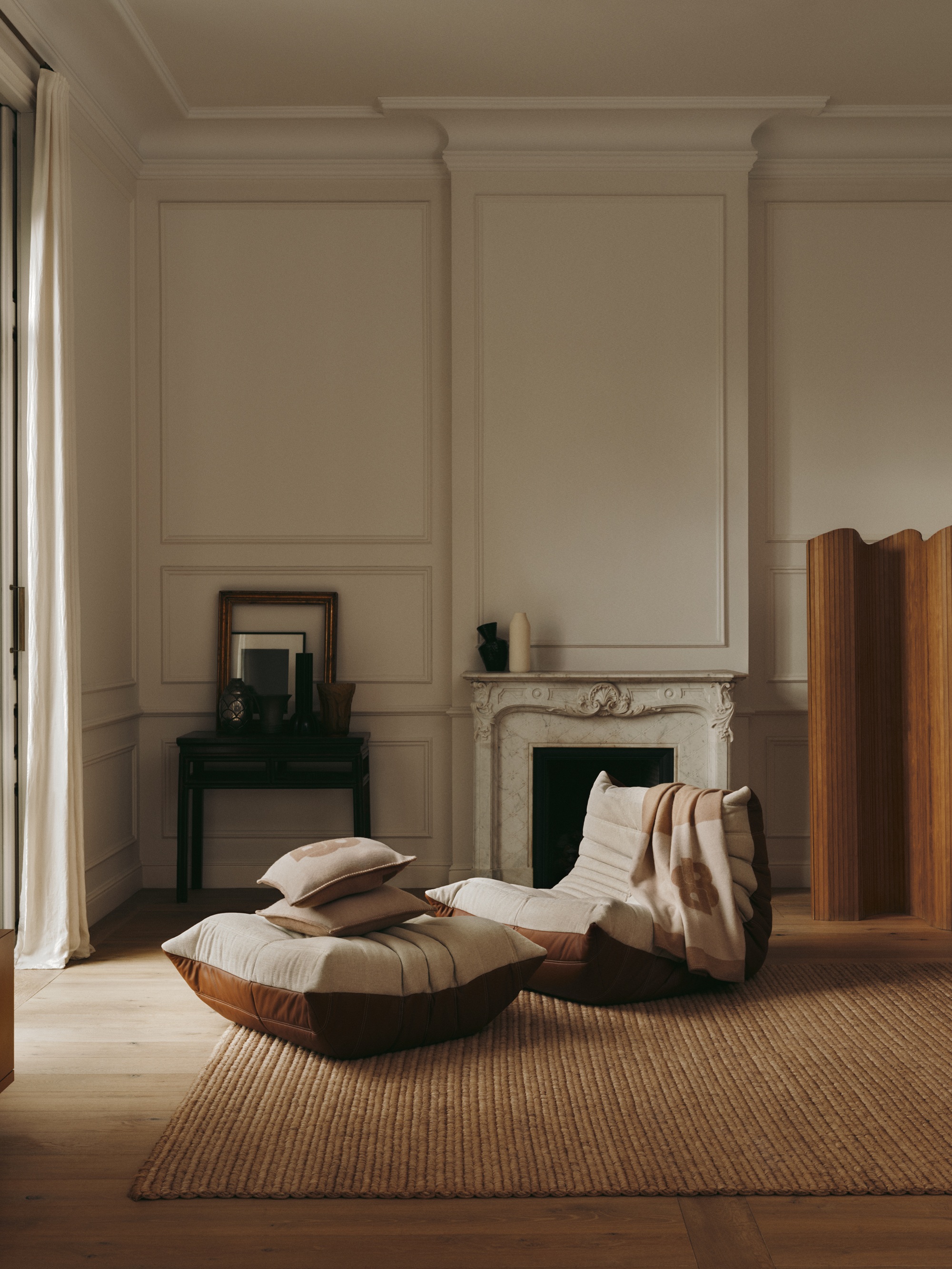 a two tone togo chair and footstool in a neutral living room