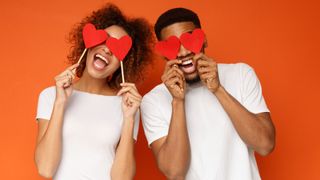 Romantic couple holding hearts