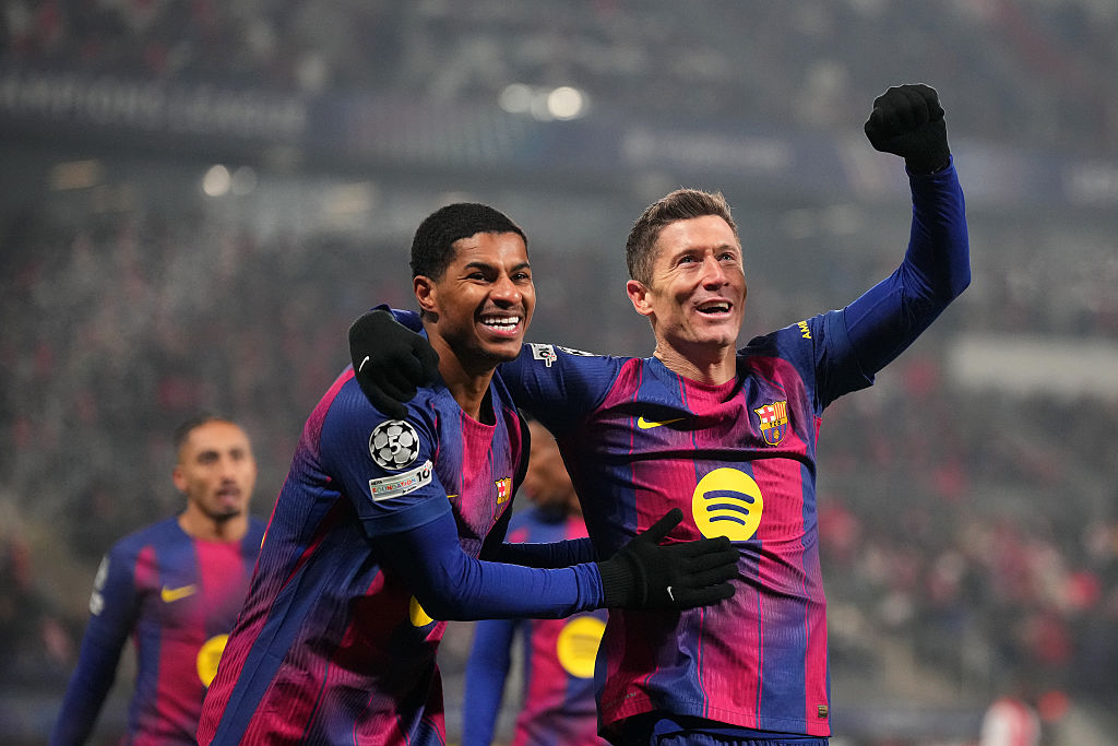 Robert Lewandowski of FC Barcelona celebrates scoring his team's fourth goal with teammate Marcus Rashford during the UEFA Champions League 2025/26 League Phase MD7 match between SK Slavia Praha and FC Barcelona at Eden Arena on January 21, 2026 in Prague, Czech Republic