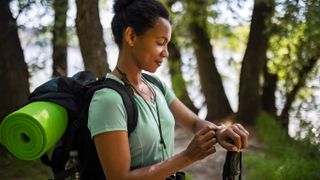 Woman checking GPS watch while hiking
