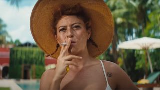 Alia Shawkat smoking on the island in Blink Twice.