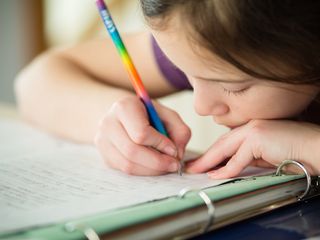 A young girl does her homework.