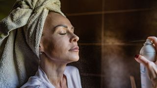 woman applying face spray