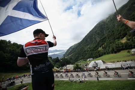 A spectator waving a Scotland flag at the Tour de France