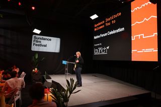 Absen LED displays illuminate the Sundance Film Festival, shown behind a presenter at a podium here.