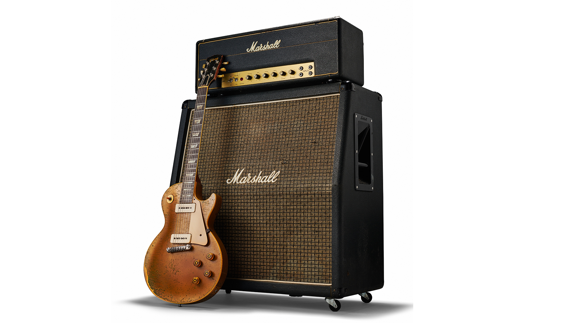 Vintage Gibson Les Paul positioned right in front of a Marshall stack