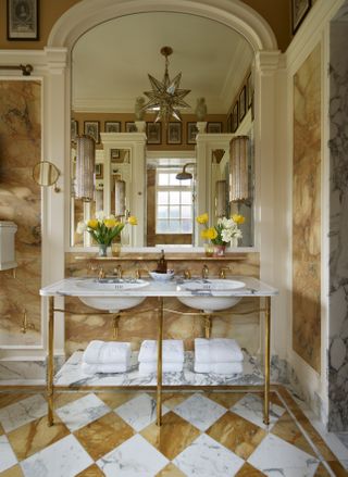 A double marble vanity with honey and white checkerboard flooring
