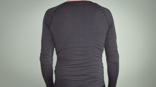 Albion merino long sleeve base layer against a green background