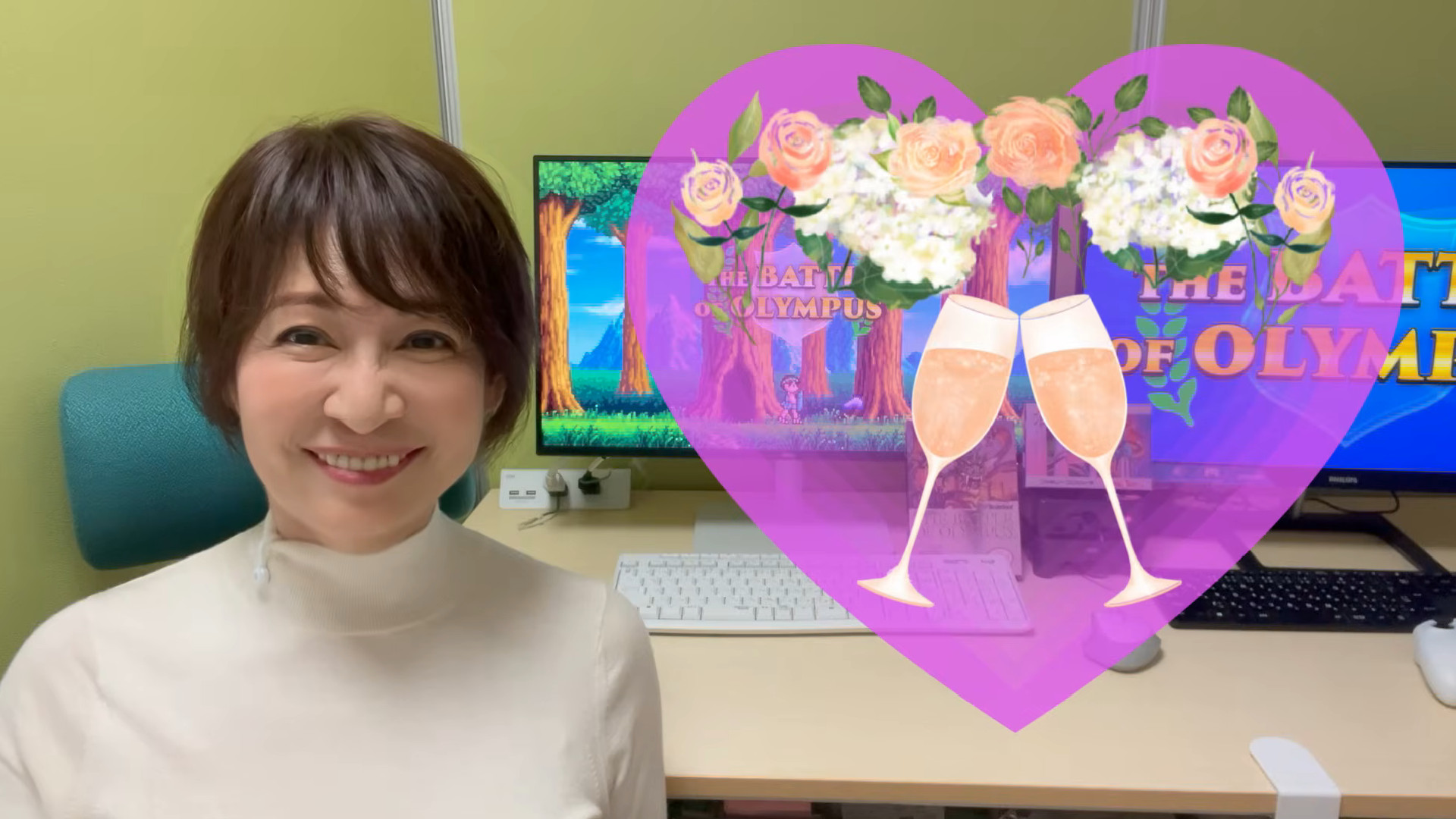 The Battle of Olympus developer Reiko Horimoto next to a heart graphic