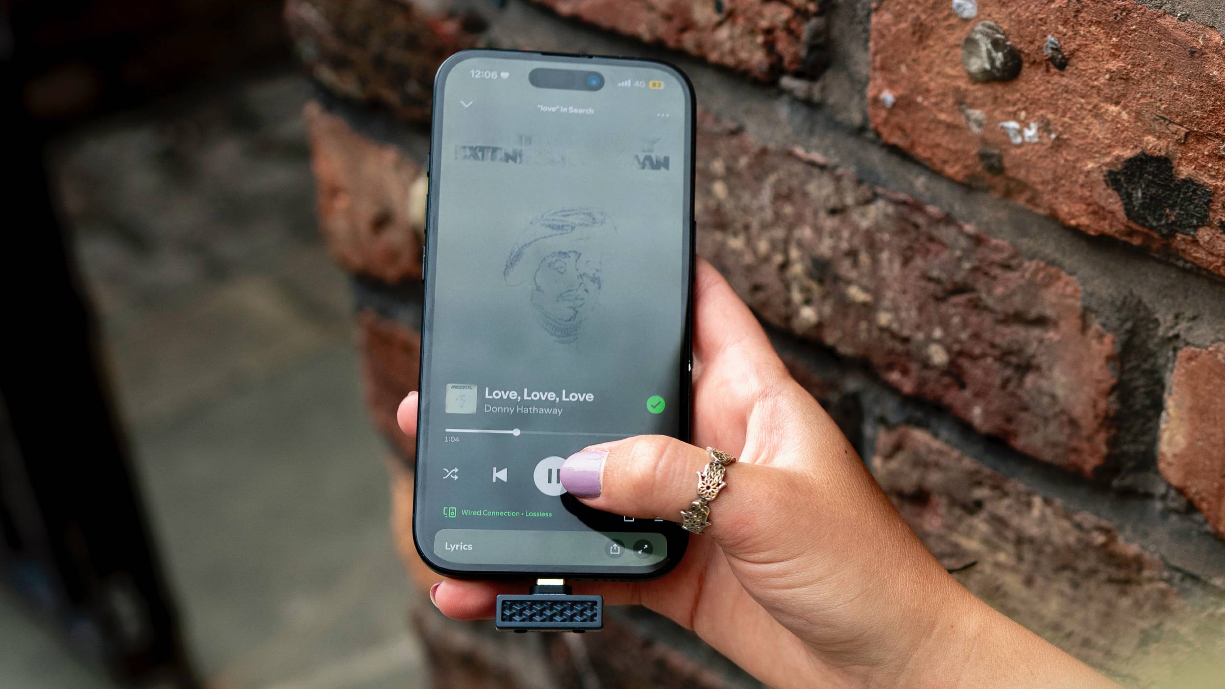 The iFi UP Play Max, on Spotify, in a woman's hand