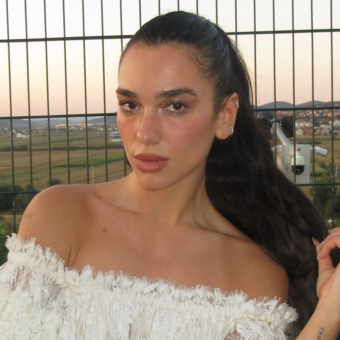 Dua Lipa pairs lace-trimmed lingerie with a track jacket for pre-fall 2026's sportif trend