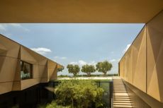 The V-shaped beverly hills house half-sunken courtyard leads to a lower level housing a bar, cinema, spa and gym