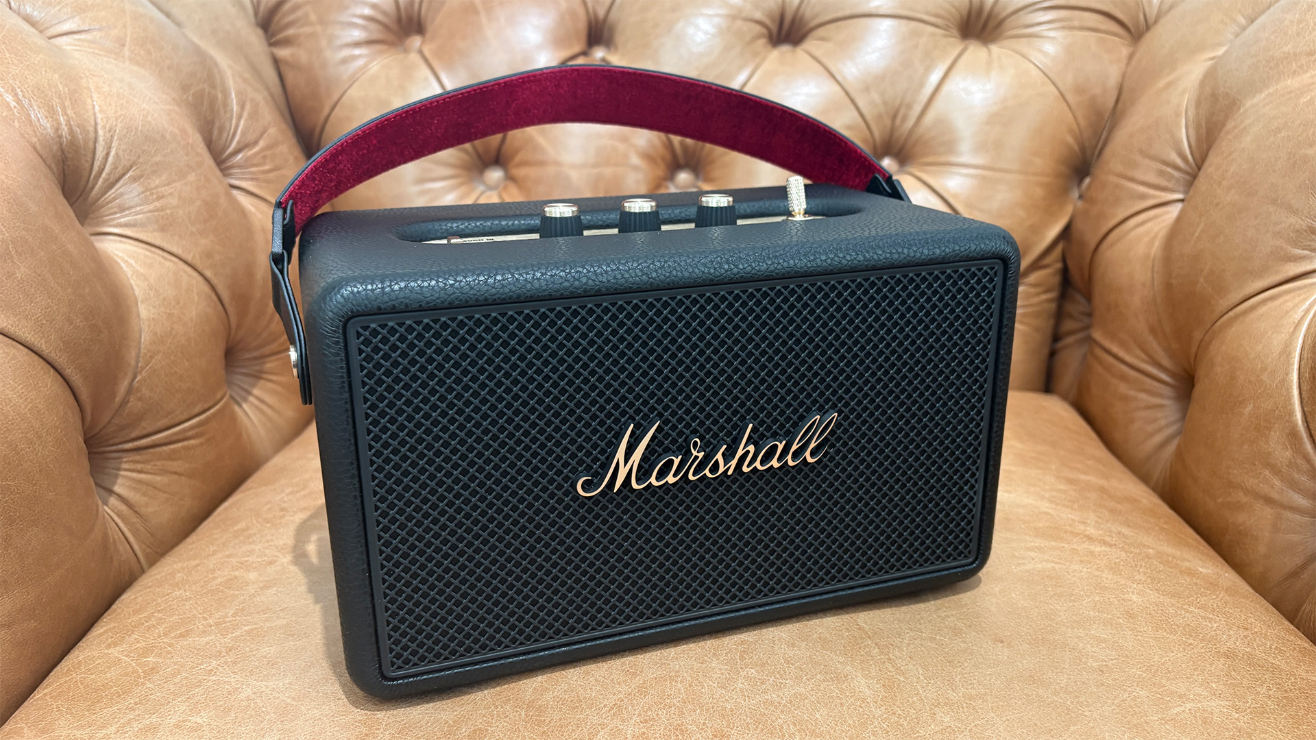 Marshall Kilburn III wireless speaker on light brown leather armchair