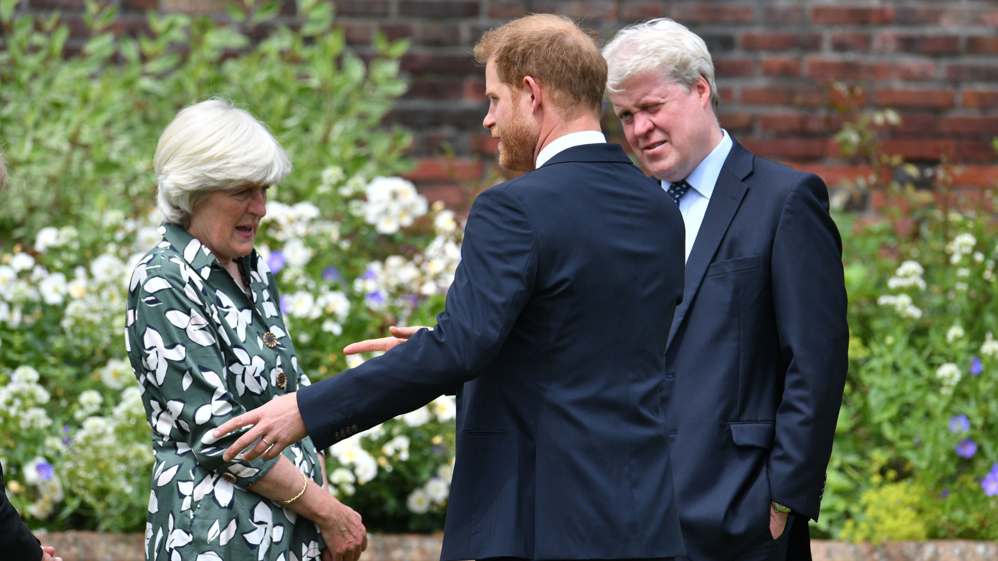 Prince Harry, Duke of Sussex with his aunt Lady Jane Fellowes and uncle Earl Spencer during the unveiling of a statue of Diana, Princess of Wales, in the Sunken Garden at Kensington Palace