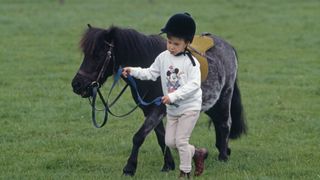 Prince William with a pony as a child