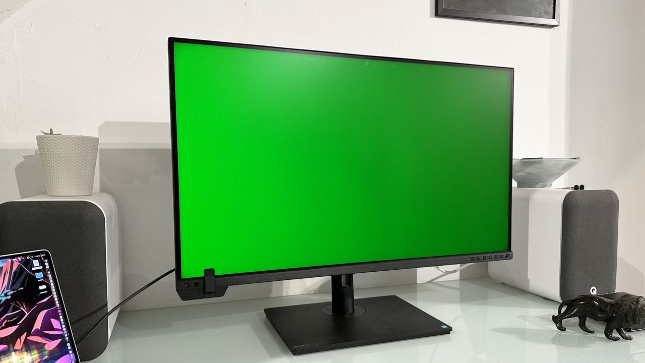 The Asus ProArt PA32KCX 8K monitor on a white desk in a home office during our review process