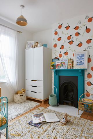 kids bedroom with a fun feature wall, fire place and kids wardrobe