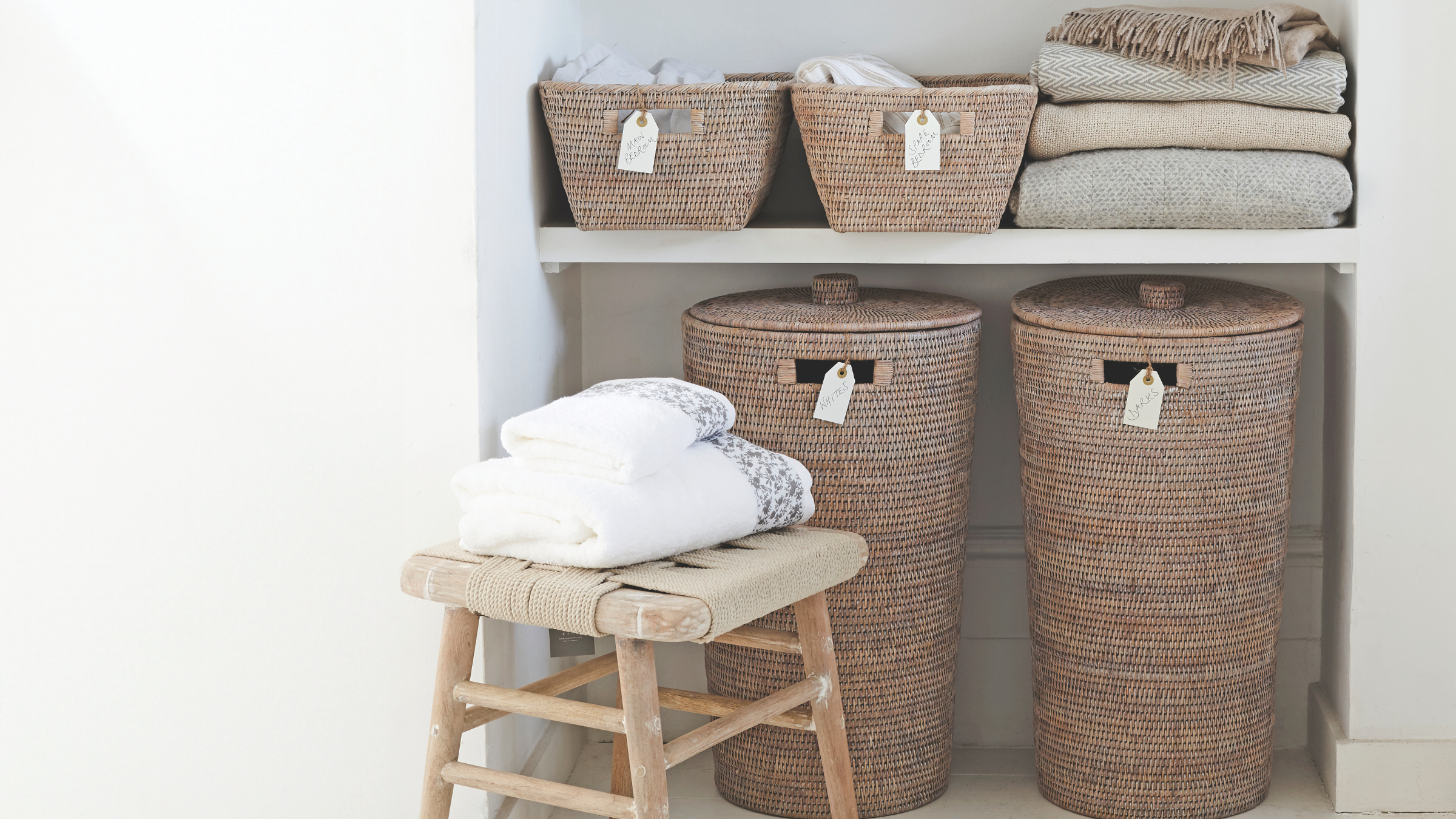 Woven laundry baskets in a cupboard.