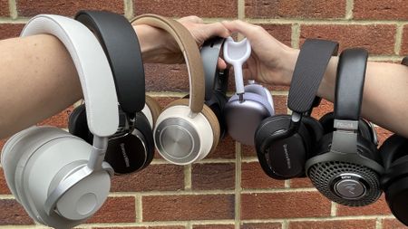 A selection of excellent over-ear headphones, on a red-brick background 