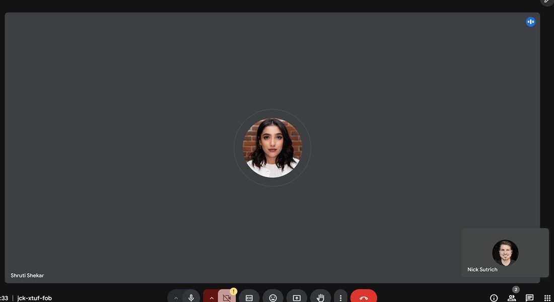 The old, bland gray tile background in Google Meet before the update color sampling.
