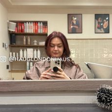 Image of beauty editor Lucy in a hair salon taking a picture of her reflection in the mirror