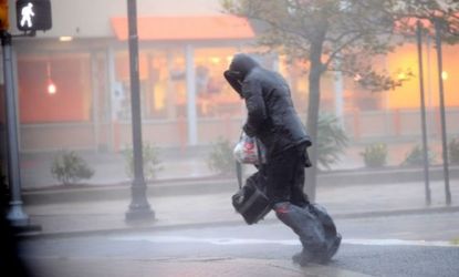 A person tries to cross the street in Atlantic City, N.J., on Oct. 29 as Sandy bears down on the East Coast. 