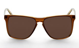 Eye wear from Han Kjobenhavn, Denmark. A rounded pair of sunglasses with a shiny brown frame.