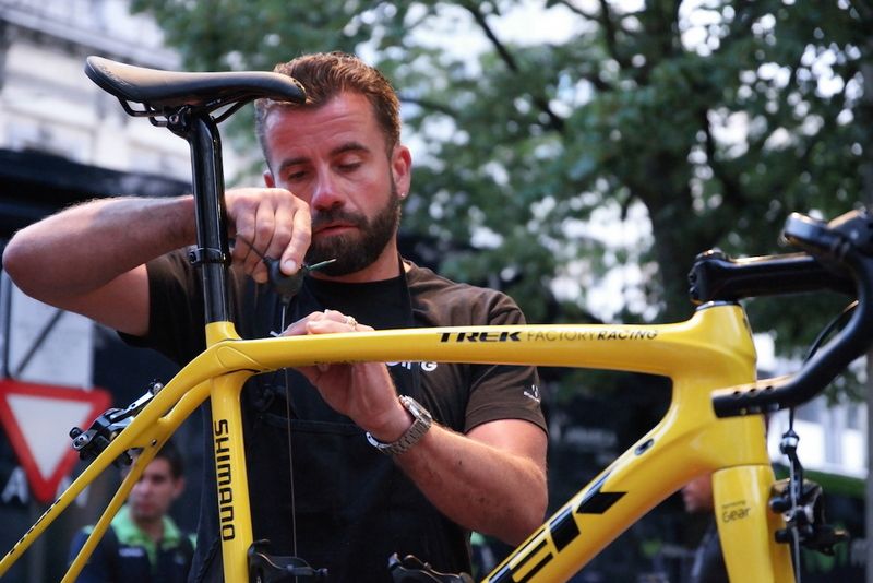Mechanics works on Fabian Cancellara's bike fitting the cables