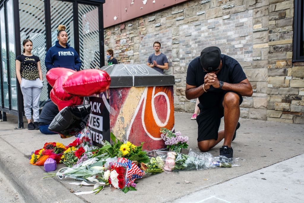 Protesters gather outside the Minneapolis storefront where George Floyd was arrested.