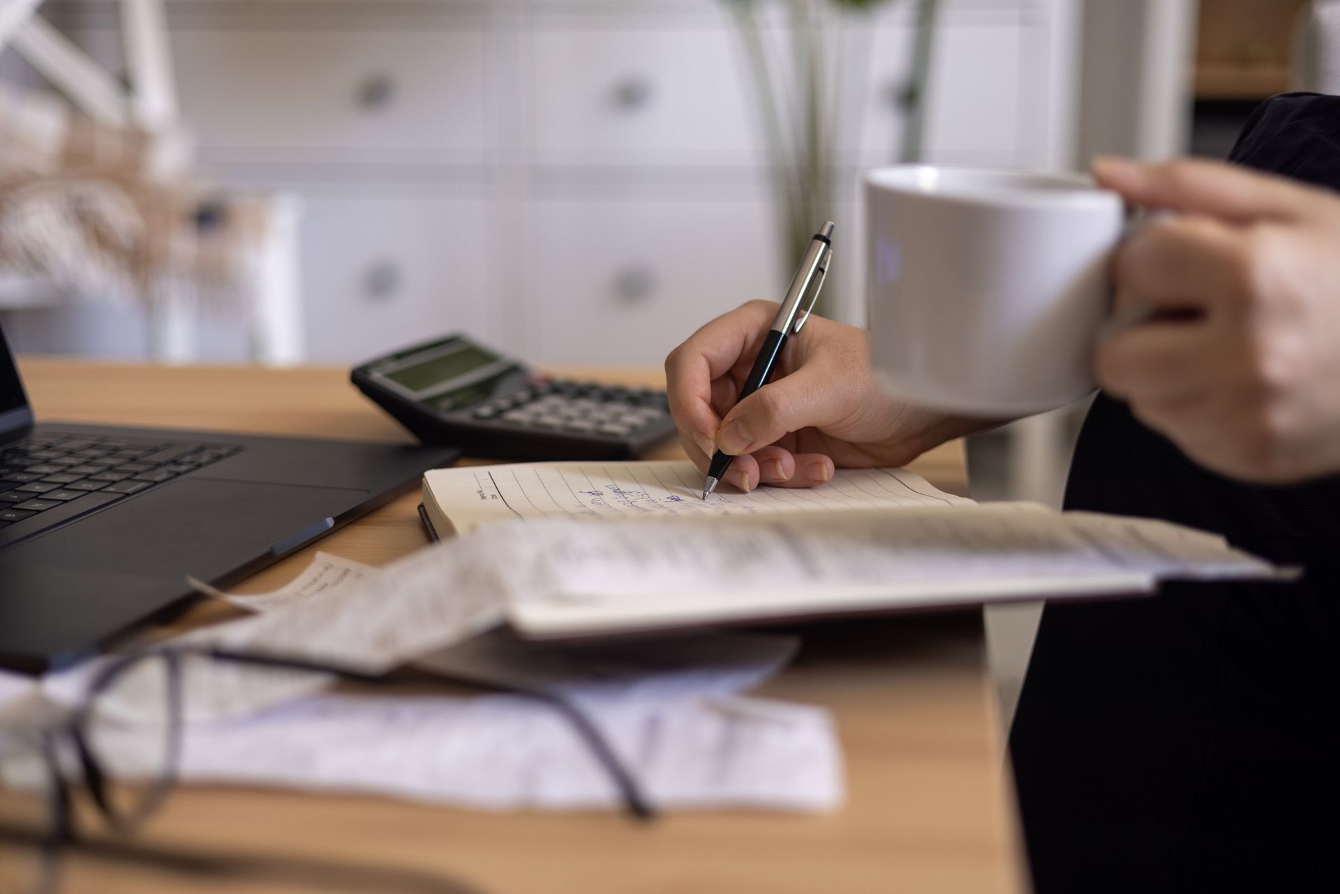 Close up of a mid adult woman checking her monthly expenses