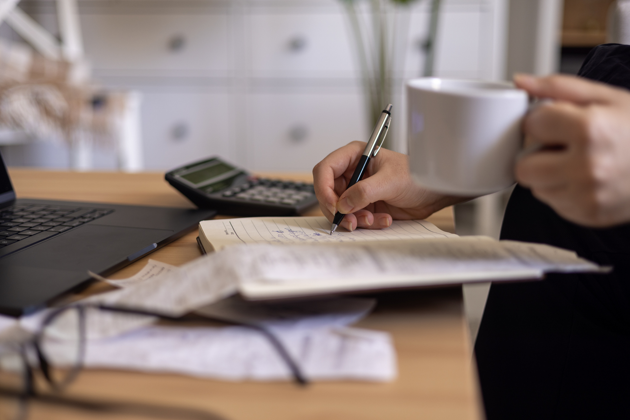 Close up of a mid adult woman checking her monthly expenses