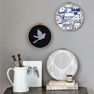 grey wall with embroidery hoops and fabric