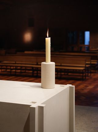 Candle in holder on white table