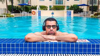 Alex Bracetti wearing solar-powered headphones in a swimming pool