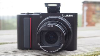 Panasonic Lumix ZS200 point and shoot camera on a wooden bench