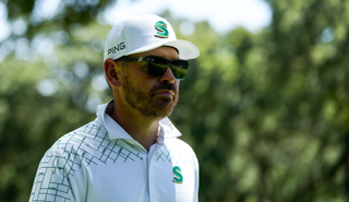 Louis Oosthuizen walks down the fairway with sunglasses on