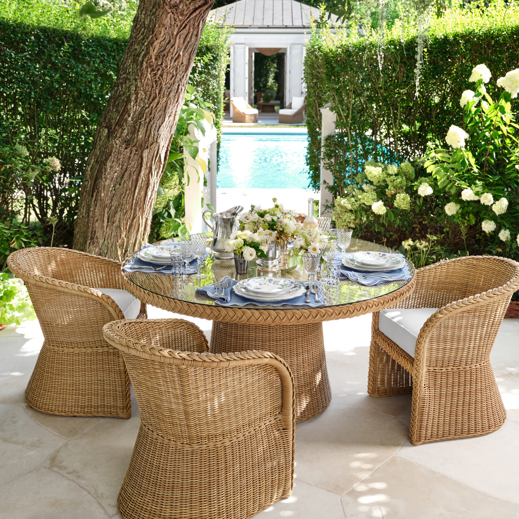 wicker furniture by. a pool