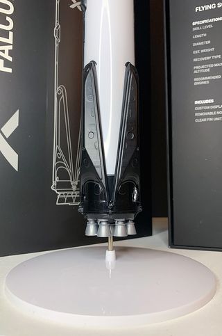 Estes' SpaceX Falcon 9 model rocket features molded landing legs and a display cap with nine Merlin engine nozzles.