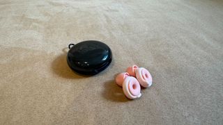 Loop Switch earbuds on a pink surface