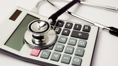 Stethoscope on calculator Medicare costs