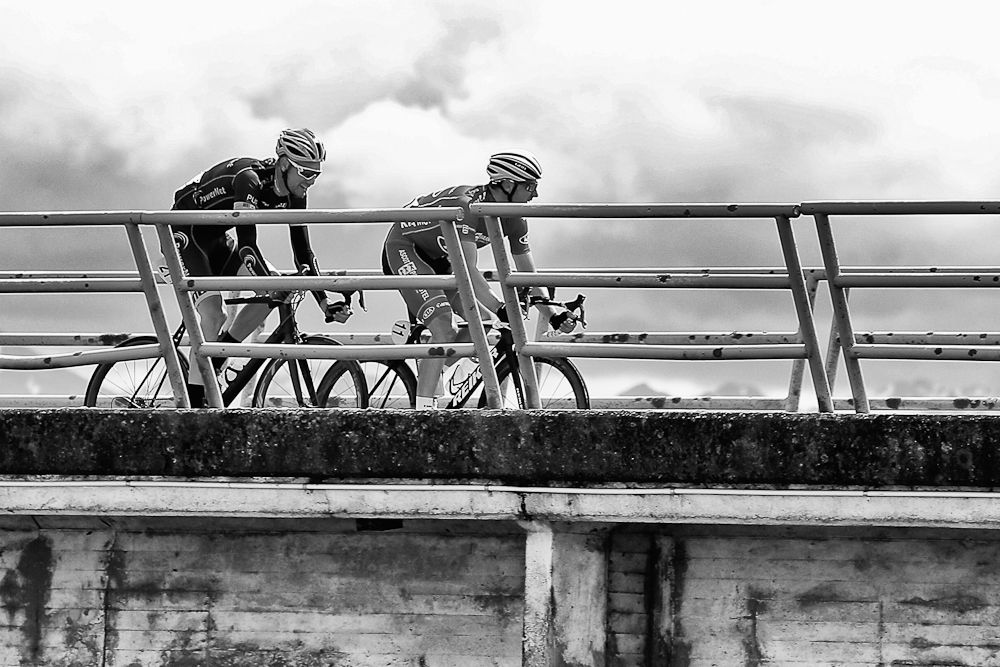 Roman van Uden (L) of Auckland and Marc Ryan of Timaru pass over the Aparima river as they head towards Lumsden in stage one of the Tour of Southland