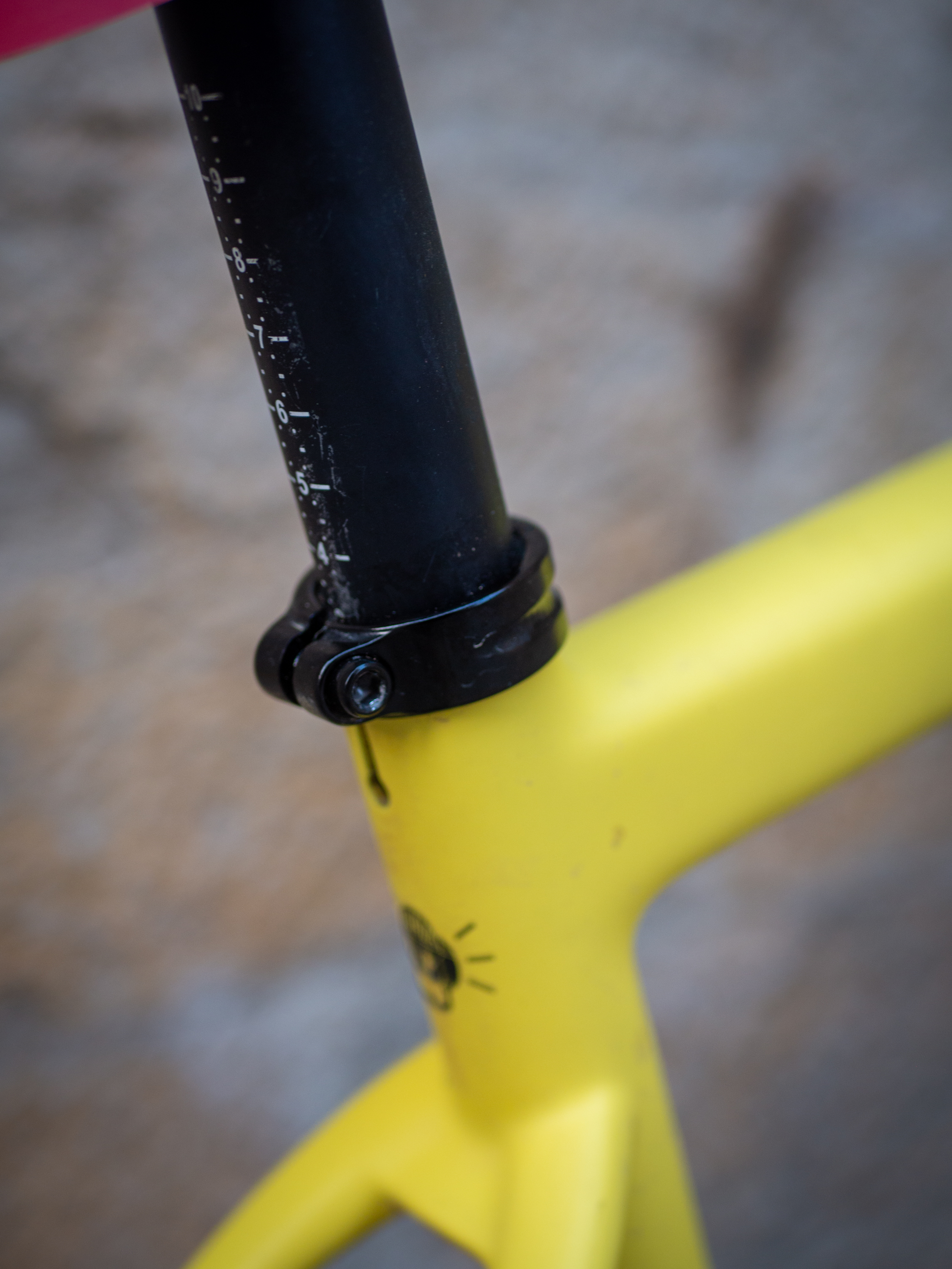 A yellow Guava Spot gravel bike leans against a wall