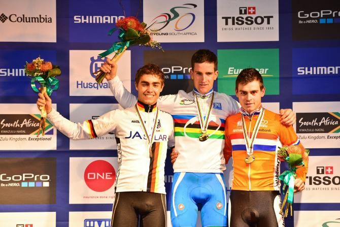 Second place Julian Schleb (left), winner Gerhard Kerschbaumer of Italy (centre) and third place Michiel van der Heijden of Netherlands (right) take to the podium after the men's under 23 cross country