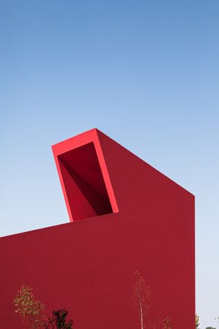 Future Architecture Thinking designs the flame-red House of the Arts in Miranda do Corvo