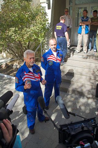 Astronaut Owen Garriott assists his son, Richard Garriott