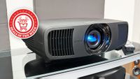 A picture of the black Epson EH-LS9000 with the Deals of the Week logo overlaid